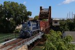 1501 pulls across the Black River bridge while picking up two more cars